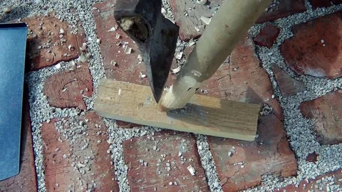 Cut an ax with a bar Stock Footage 74395817