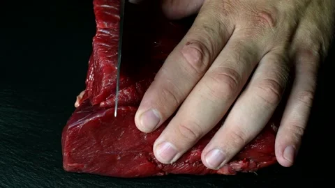 Cut beef meat close-up on a dark background 4k Stock Footage 136665955