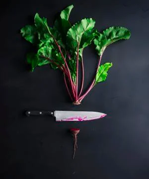 Cut beetroot and knife on a black background Stock Photos