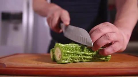 Cut bitter gourd with a kitchen knife to remove the pulp of bitter gourd (2) Stock Footage 202157072
