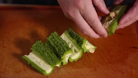 Cut bitter gourd with a kitchen knife to remove the pulp of bitter gourd (3) Stock Footage 202158396