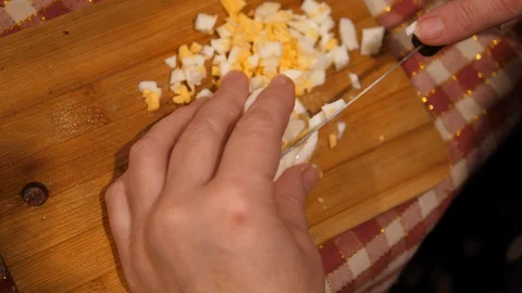 Cut boiled Egg on Board with Knife. Cooking Salad at Home. Homemade food. 库存影片 127793639