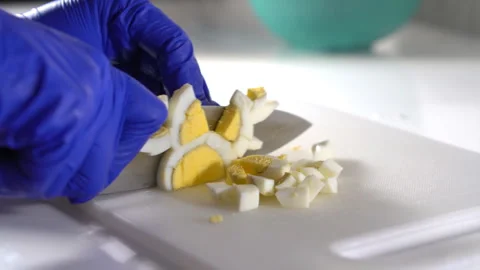 Cut boiled eggs into small pieces with a knife Stock Footage 300479802