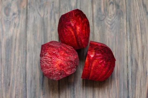 Cut boiled Fresh red beetroot on dark wooden background. Selective focus. Mac Stock Photos