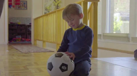 Cut boy doesn't know what to do with his soccer ball Stock Footage 64363673