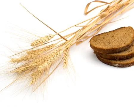 The cut bread and ears of wheat Stock Photos
