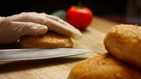 Cut the bread for the burger into two parts. Tasty Low-Calorie Green Burgers Stock Footage 156723971