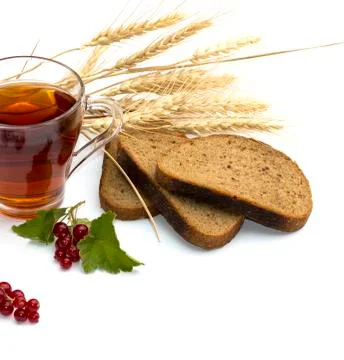 The cut bread, tea, wheat and currant Stock Photos