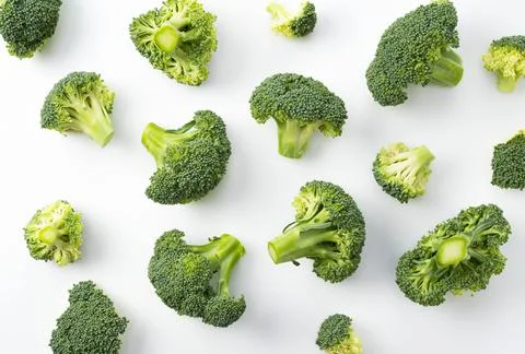 Cut broccoli placed on a white background Stock Photos