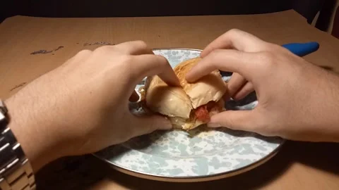 Cut a Burger into two pieces Stock Footage 256574703