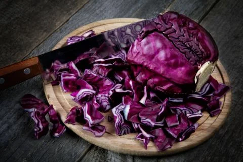 The cut cabbage and kitchen knife on an old table Stock Photos