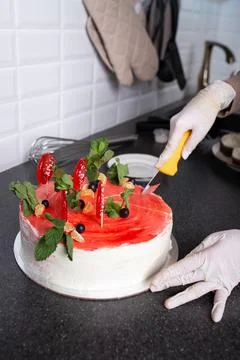 Cut the cake with a knife on the work surface Stock Photos