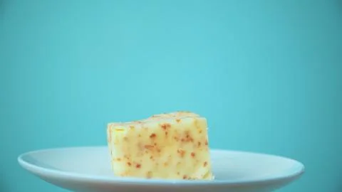 The cut cake rotates on a white plate Fotos de archivo