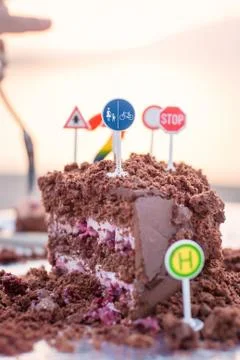 Cut cake on sunset background Stock Photos
