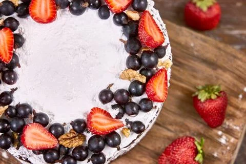 A cut of cake with whipped cream and strawberry fruits on wood table Stock-Fotos