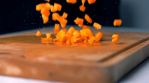 The cut carrots fall on the cutting board. Slow motion Stock Footage 105092271