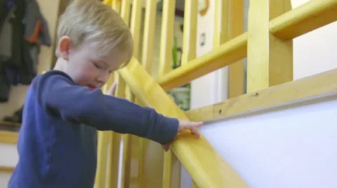 Cut child runs down some house steps Stock Footage 65506085