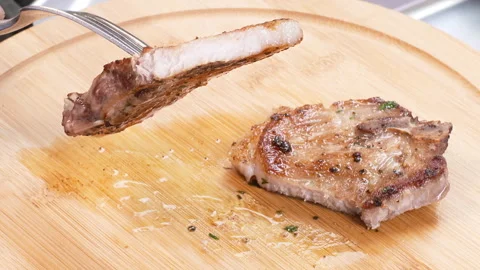 Cut Cooked Pork Chop on a table Stock Footage 248747021