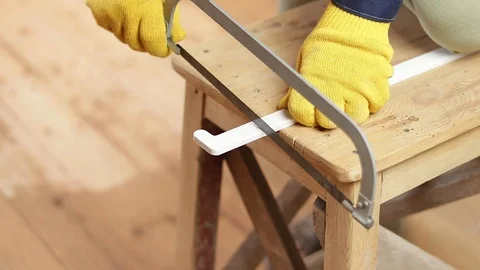 To cut a corner with a plastic hacksaw Stock Footage 129138009