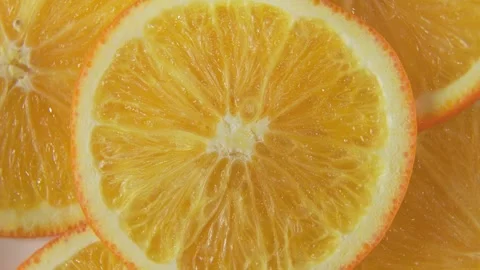 Cut crosswise slices of orange in a circular motion macro shot Stock Footage 332081401