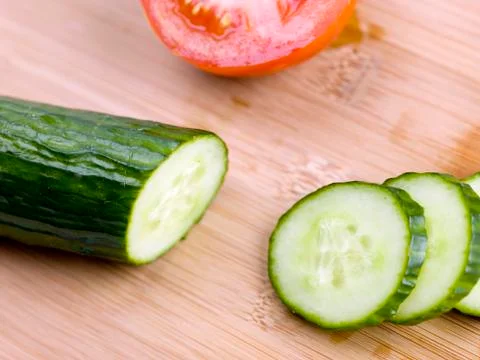 Cut cucumber with tomato Stock Photos