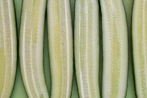 Cut cucumbers in half lengthwise on a cutting Board green Stock Photos