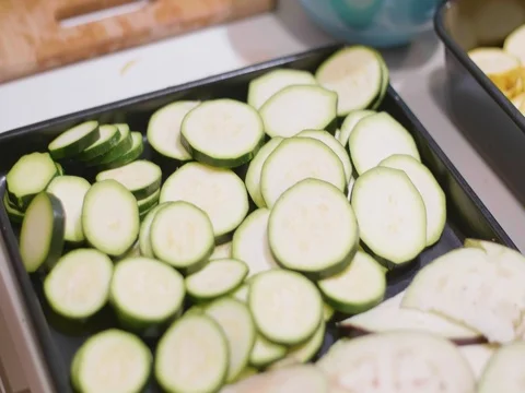 Cut up cucumbers in slow motion Stock Footage