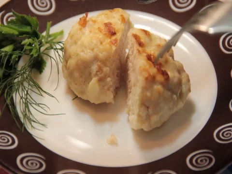 Cut a cutlet on a plate with a knife Stock Footage 77002974
