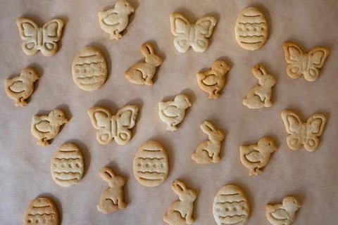 Cut from the dough cookies in the form of Easter symbols of egg, rabbit, butt Stock Photos