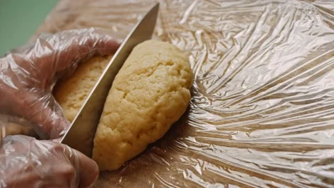 Cut the dough into two pieces. 4k video Stock Footage 159975563