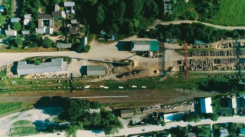 Cut down trees on the territory of the sawmill, top view. shooting drone Video stock 94975906
