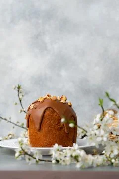 Cut Easter cake on plate decorated with spring flower branches Stock Photos