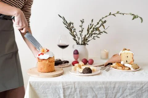 Cut easter cake in womans hand. Easter traditional orthodox sweet bread, kuli Stock Photos