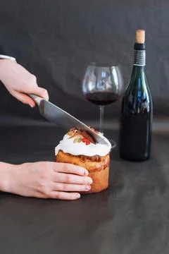 Cut easter cake in womans hand. Easter traditional orthodox sweet bread, kuli Stock Photos