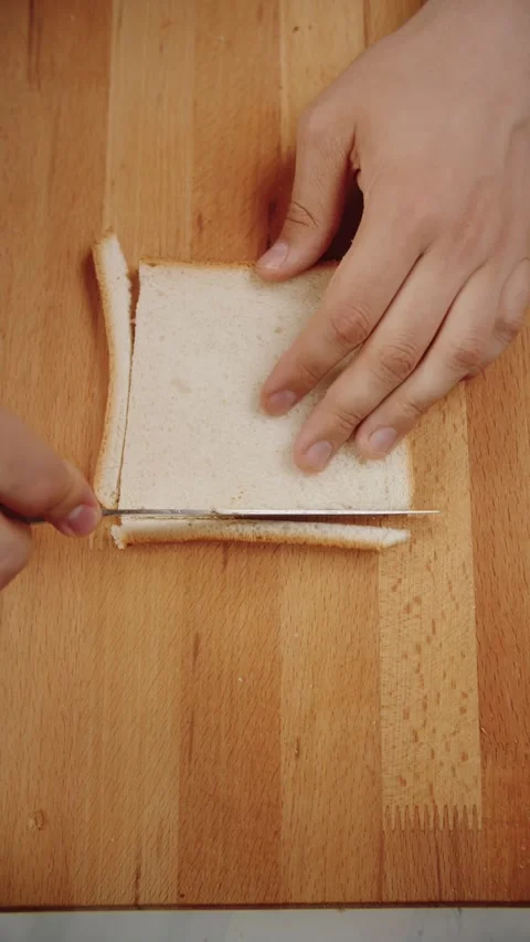 Cut the Edges of the Bread for Cooking Video stock 281918774