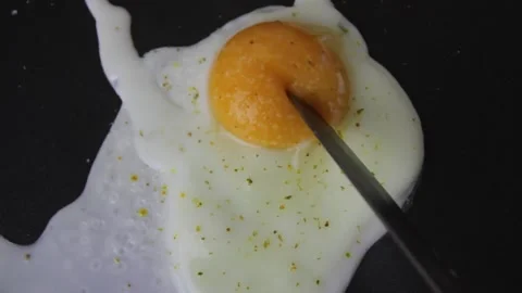 Cut the egg. Cooking Fried egg in a frying pan for breakfast Stock Footage 163489228