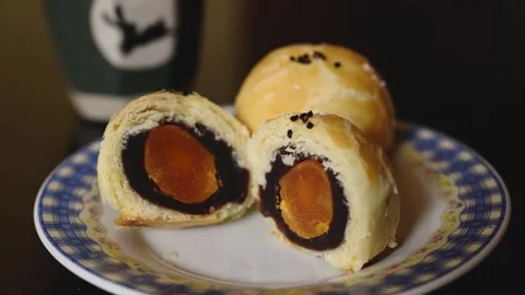 Cut Egg Yolk Pastry Served with Tea for Mid Autumn Festival Stock Footage 345669862