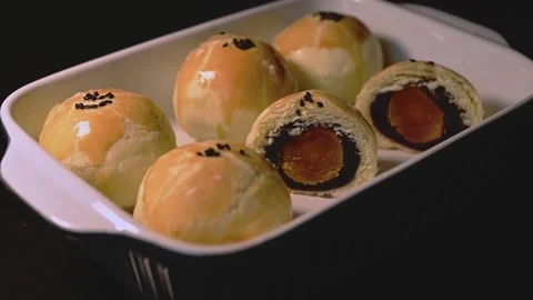 Cut Egg Yolk Pastry Served with Tea for Mid Autumn Festival Stock Footage 345669879