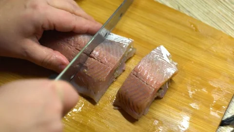 Cut the fish on the table 4K Stock Footage 102447999