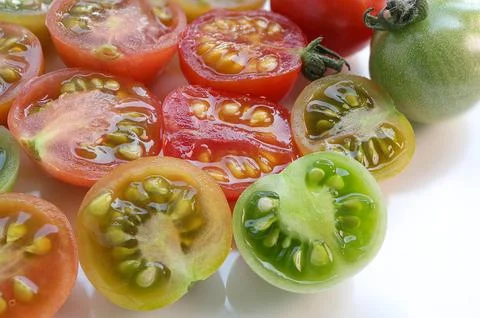 Cut fresh cherry tomatoes. red, green and orange cherry tomatoes  Stock Photos