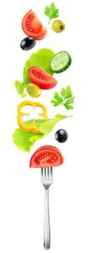 Cut fresh vegetables falling on a fork Foto stock