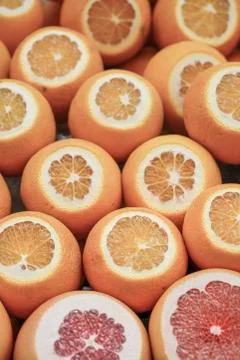 Cut grapefruit and oranges as a background Stock Photos