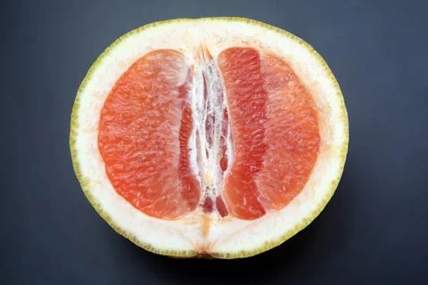 Cut grapefruit on a dark background Stock Photos
