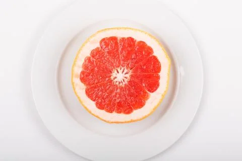 Cut grapefruit on a plate Stock Photos