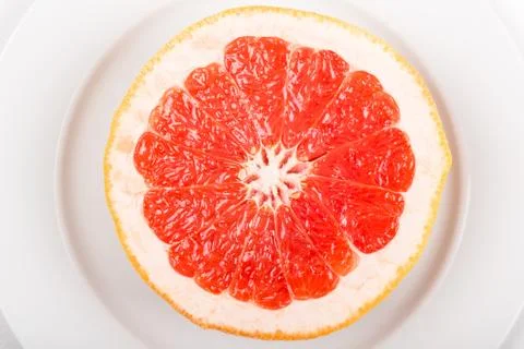 Cut grapefruit on a plate Stock Photos
