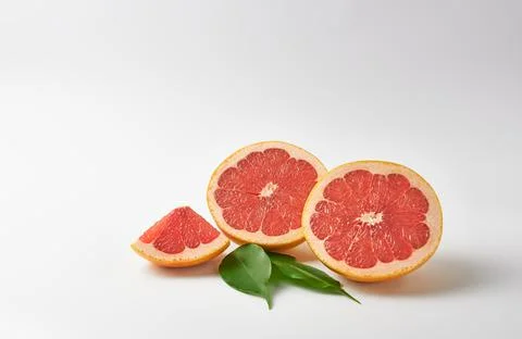 Cut grapefruit on a white background Stock Photos