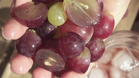 Cut grapes fall from the palm of your hand slow motion Stock Footage 89215899