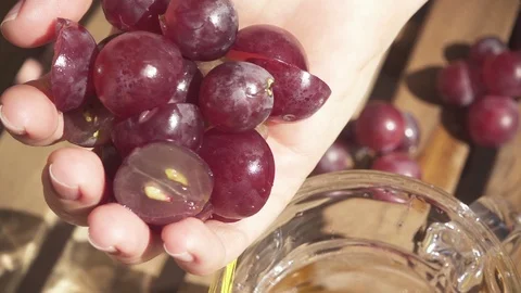 Cut grapes halves fall into the decanter slow motion Stock Footage 89087601