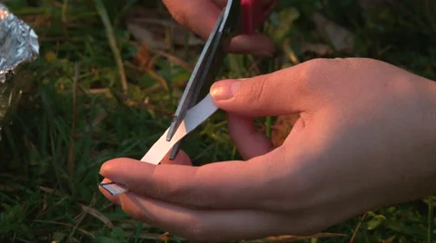 Cut gum foil to light fire, forest survival, close up shoot Stock Footage 63210460