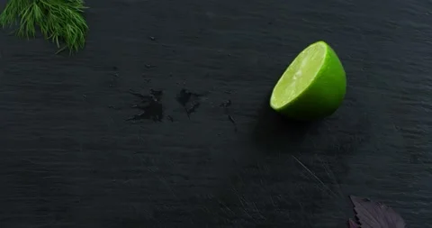 Cut in half green lime falls on the table and flies into 2 parts Stock Footage 152101000